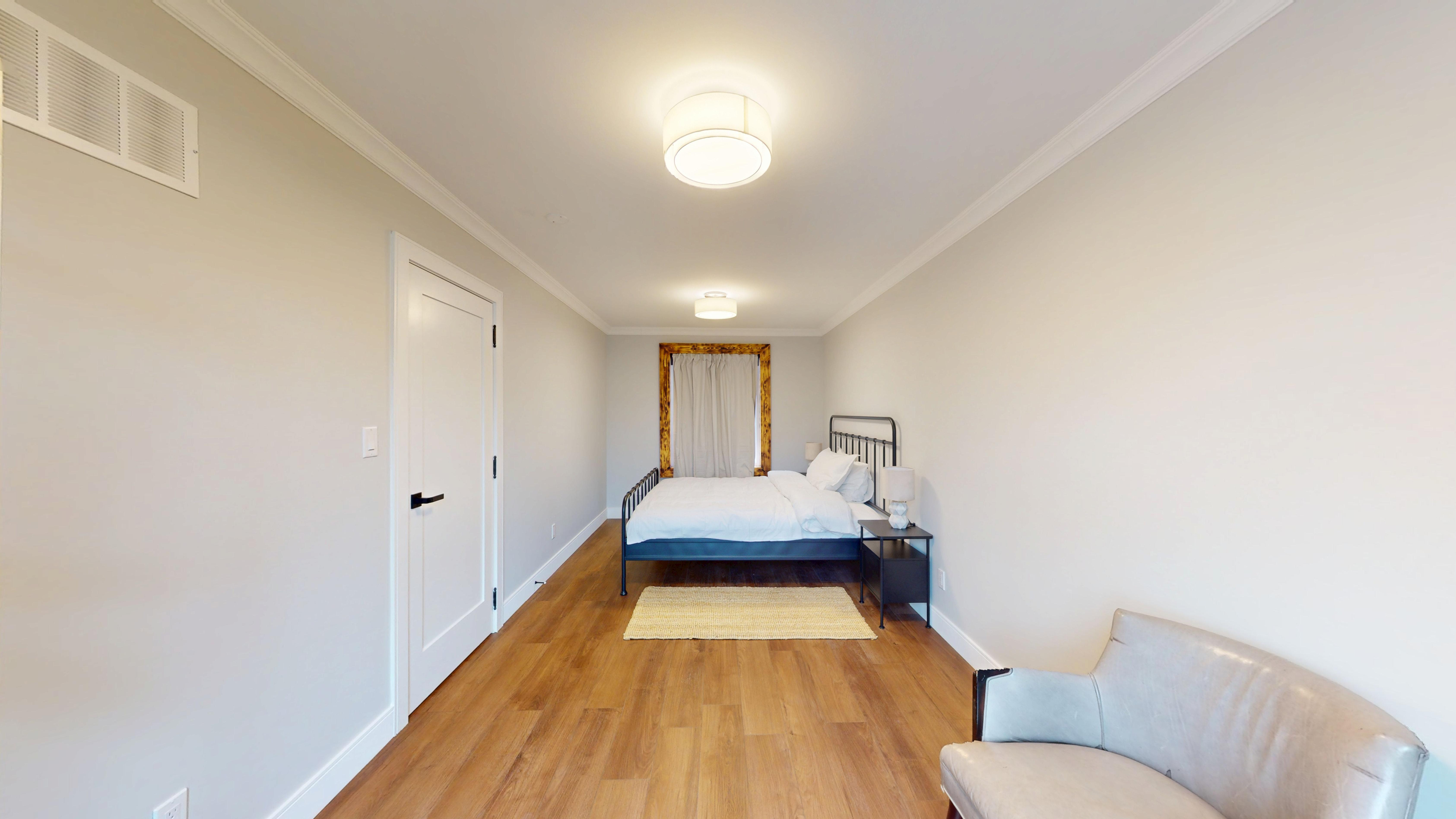 An additional upstairs bedroom with a queen bed
